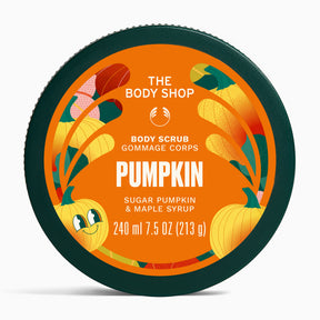 The Body Shop Pumpkin Body Scrub in a round dark green tub with a bright orange label featuring pumpkins and autumn leaves.