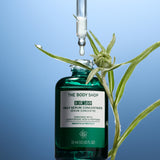 The Body Shop Edelweiss Daily Serum Concentrate with a dropper and plant on a blue background