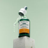 The Body Shop Vitamin C Glow Serum bottle sat on top of a stone block.