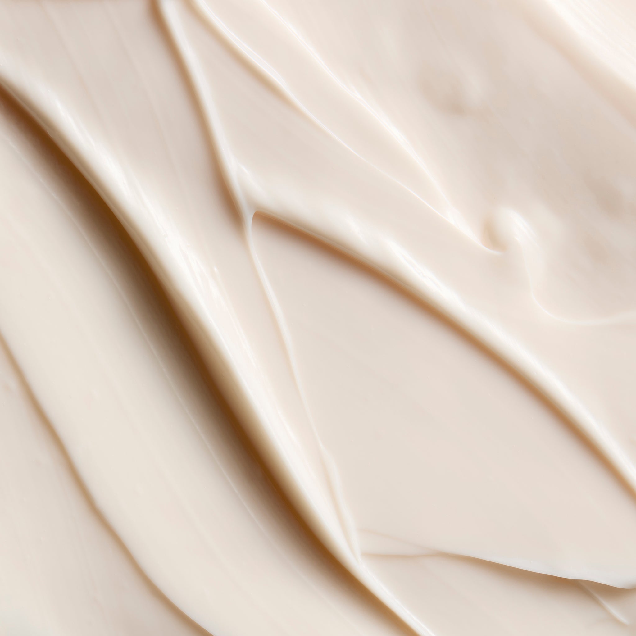 Close-up of smooth Strawberry body butter cream, showing soft swirls and a rich, creamy texture | The Body Shop
