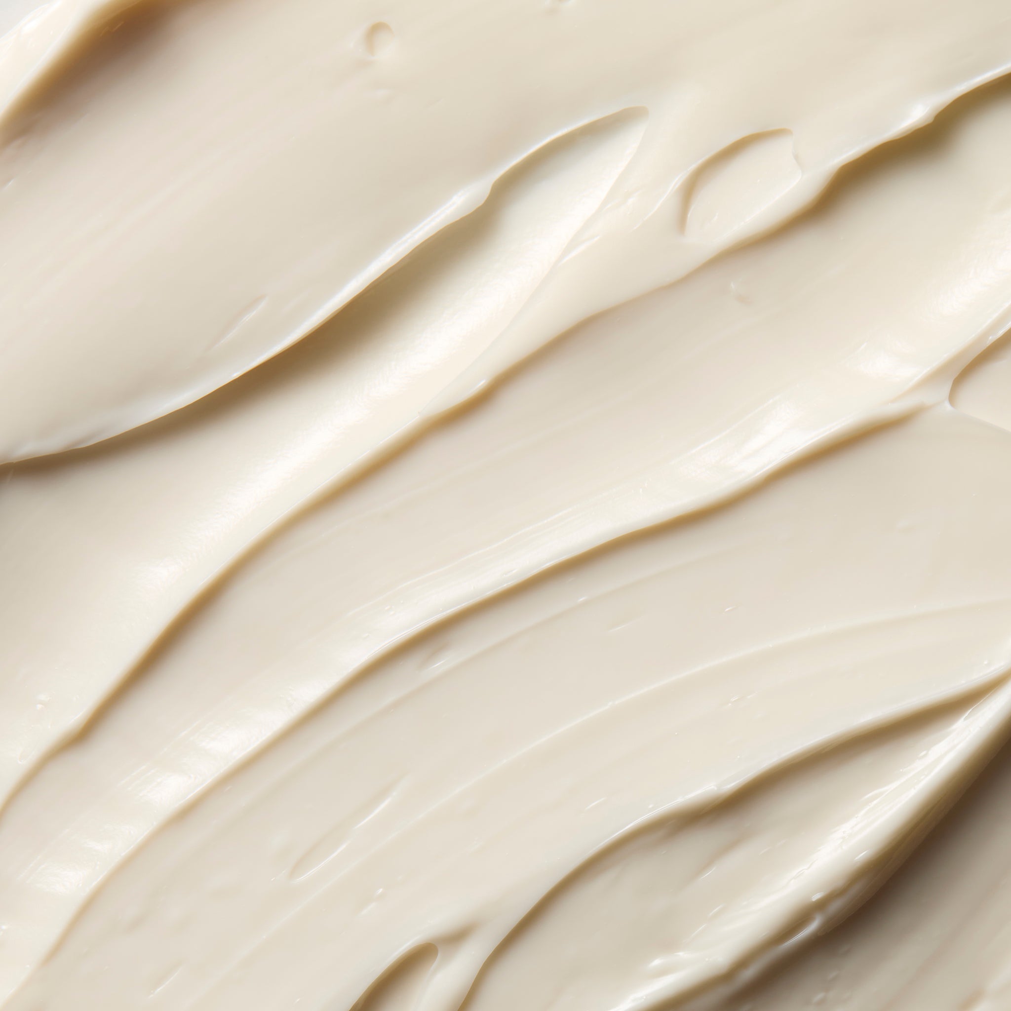 Close-up of smooth Coconut body butter cream, showing soft swirls and a rich, creamy texture | The Body Shop