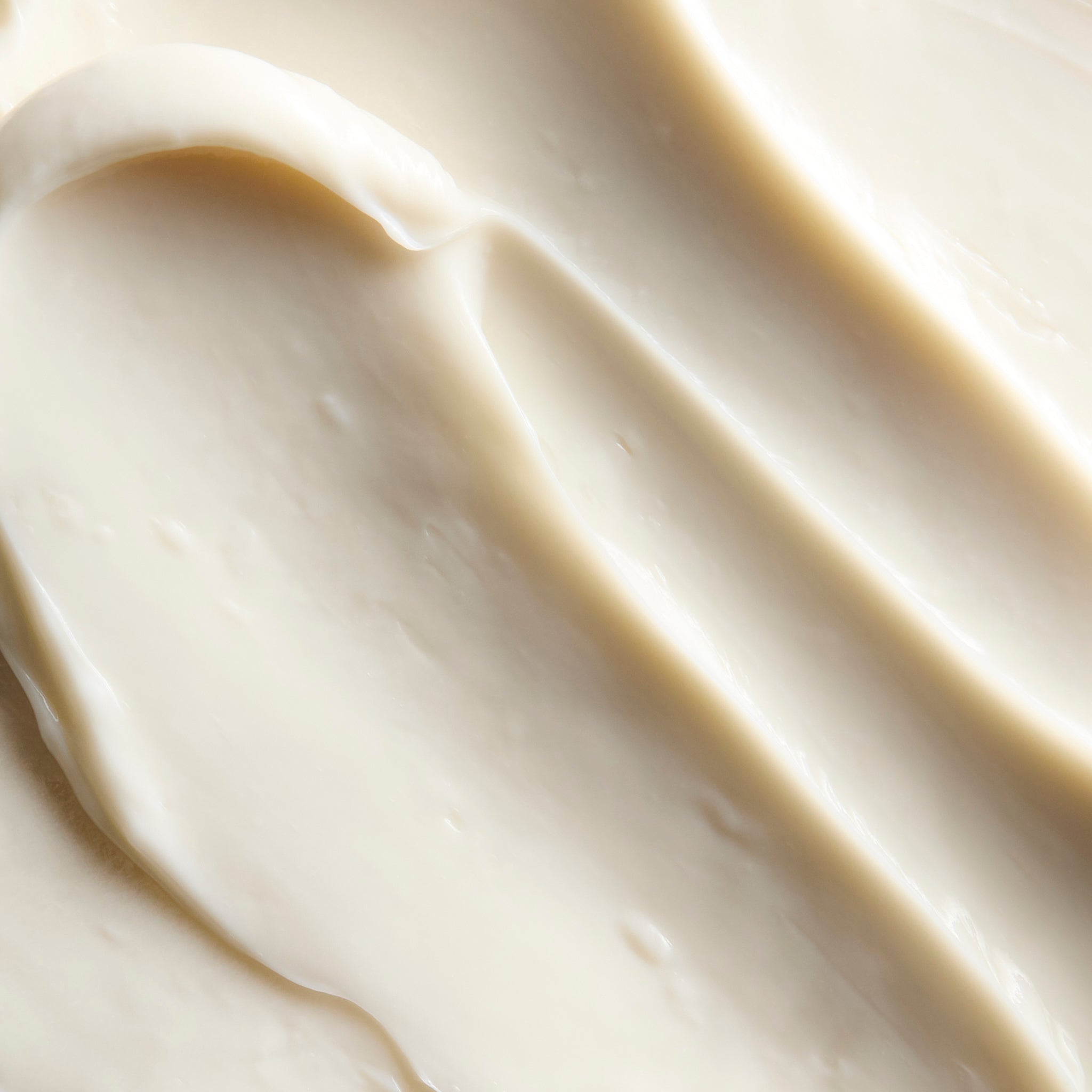 Close-up of smooth Shea body butter cream, showing soft swirls and a rich, creamy texture | The Body Shop