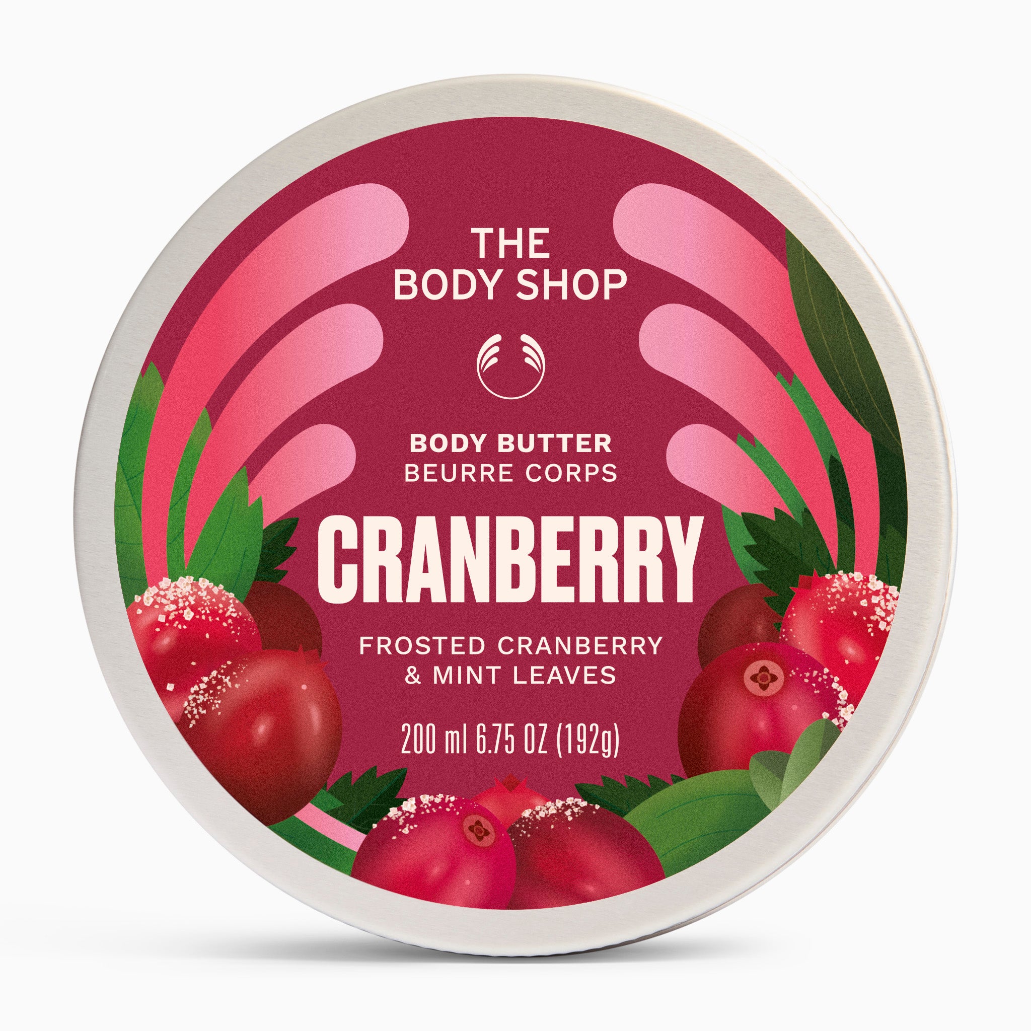A round tin of The Body Shop Body Butter in Cranberry, featuring a vibrant label with illustrations of fresh cranberries, mint leaves, and pink hand shapes on a white background.