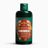 A 250 ml bottle of The Body Shop Gingerbread Shower Cream, featuring a dark green bottle and cap with a brown and orange label, set against a plain white background.