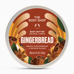 A round tin of The Body Shop Gingerbread Body Butter, featuring a warm brown label with illustrations of cinnamon sticks, star anise, and leaves, set against a clean white background.