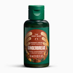 A 60 ml bottle of The Body Shop Gingerbread Shower Cream, featuring a dark green translucent bottle, a matching green flip-top cap, and a brown and orange label with illustrations of gingerbread and spices.