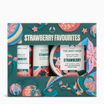 The Body Shop Strawberry Favourites gift set, featuring three products (body gel, hand cream, and body butter) in a decorative teal box with strawberry and citrus illustrations.
