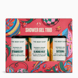 The Body Shop Shower Trio gift set in a bright red patterned box, containing three small shower gel bottles labelled Strawberry, Almond Milk, and Satsuma.