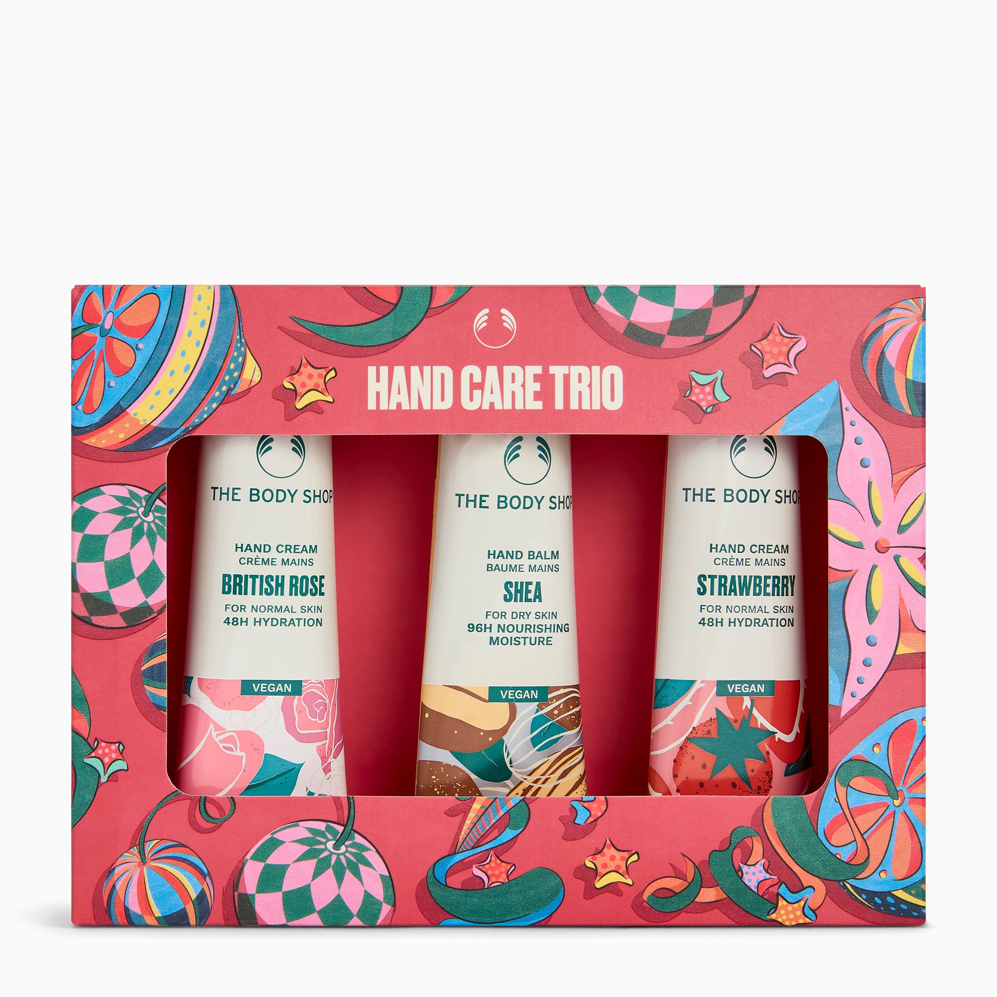 The Body Shop Hand Care Trio gift set in a pink patterned box, containing three tubes: British Rose, Shea, and Strawberry hand creams.