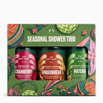 The Body Shop Seasonal Shower Trio gift set in a bright green patterned box, containing three small shower gel bottles labelled Cranberry, Gingerbread, and Matcha.