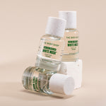 Three bottles of The Body Shop White Musk perfume on a beige background