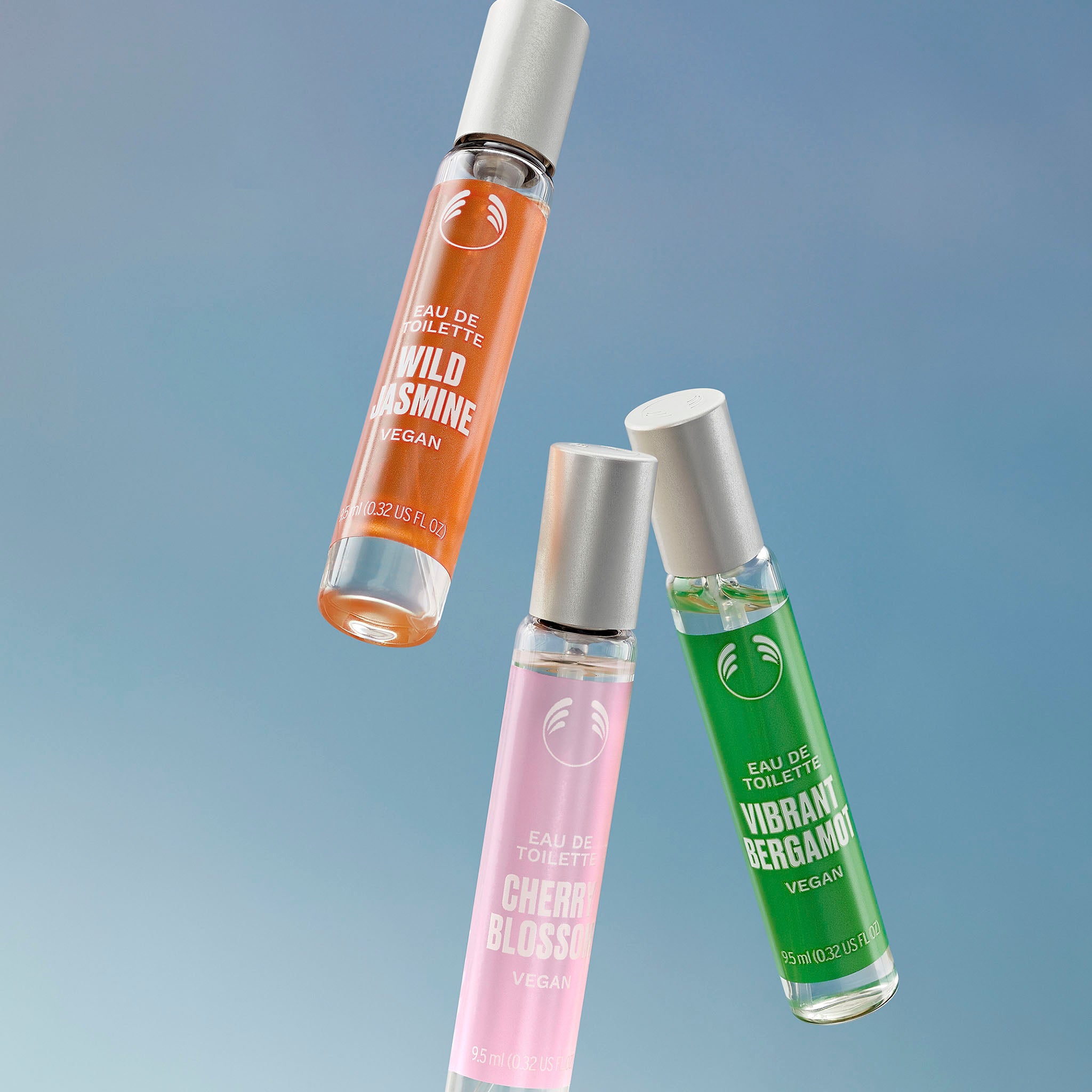 X3 9.5ML Eau De Toilettes thrown up across a blue background - The Body Shop