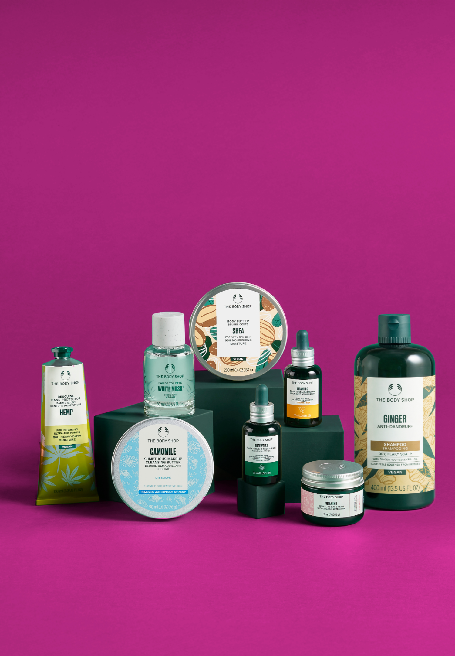 Collection of skincare and hair care products on a magenta background