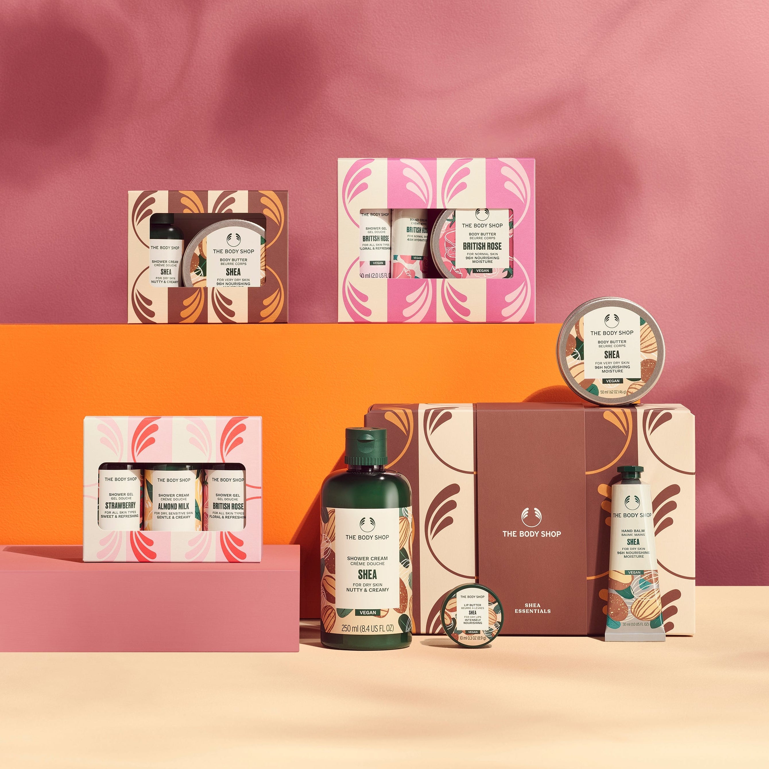 Collection of skincare products on a pink and orange background