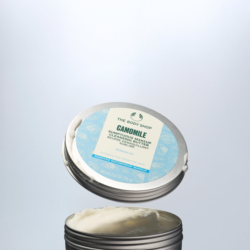 The Body Shop Camomile cleansing balm with open lid on a light gray background