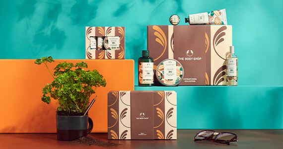 Collection of The Body Shop products on a teal and orange background